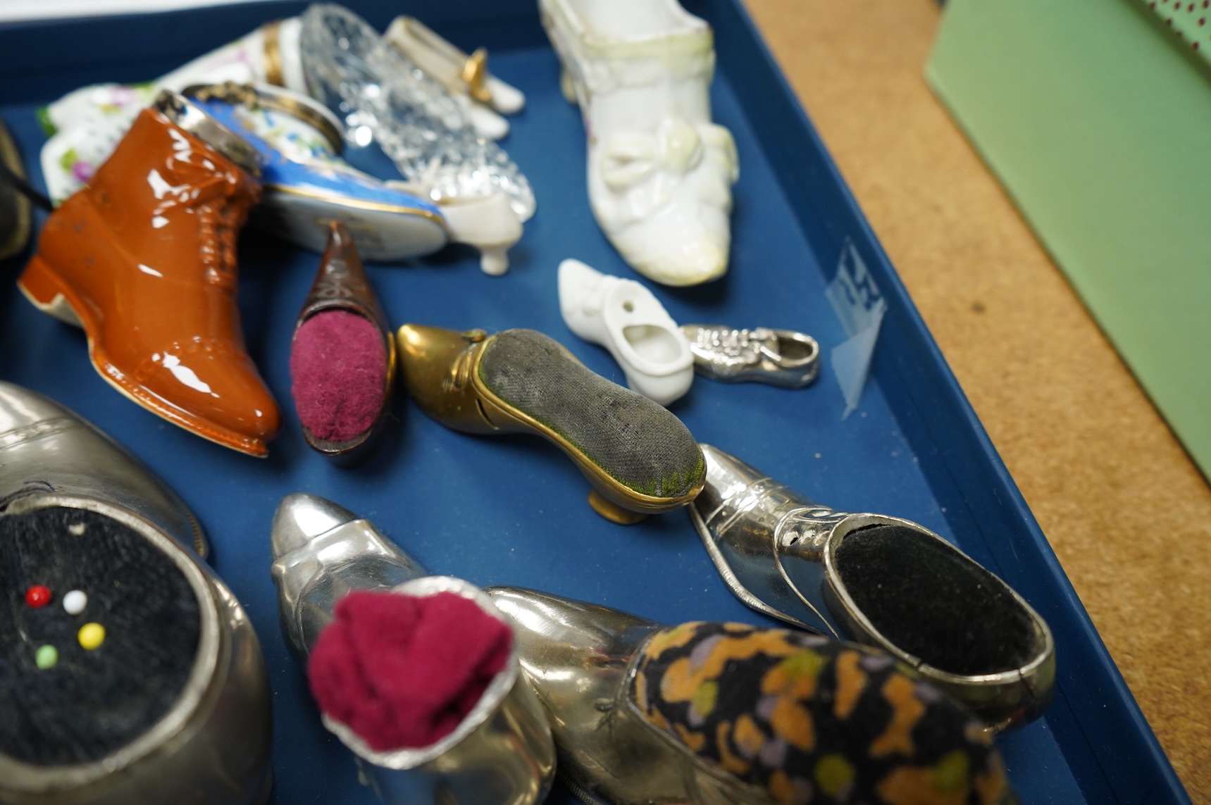 A collection of assorted miniature model shoes including pin cushions, one with modern silver mount